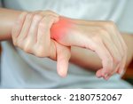 Woman has wrist pain due to heavy use. Health care concept.