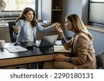 Angry boss yelling at her employee, she is stressed and feeling frustrated on work.Young ambitious female boss yelling at new unhappy female employee.Mobbing at work.
