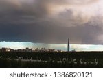 Small photo of huge thundercloud on the outskirts of the city before the rain - image