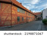 Small photo of Ystad, Sweden - 6 Sep, 2022: Old half timbered building that houses smaller businesses in a smaller town, southern Sweden durimng early morning