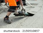 He Removes The Asphalt With A...