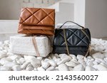 Stylish women's brown handbag. Trendy outfit woman with brown bag. Girl with bag over his shoulder outdoors. Shoulder Bags for Women. Fashion look woman outfit. Close-up.