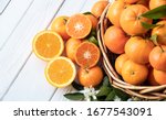 Small photo of Orange fruit with green leaves on the white wood. Home gardening. Mandarine oranges. Tangerine oranges. Orange color. Fresh orange juice.