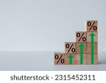 Mortgage rates,Interest rates,tax,real estate,business growth concept.,Wooden blocks stacked as stair with percent icon over white background for financial,business idea.