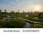 Small photo of BANGKOK, THAILAND - MAR 6, 2022 : View of Benjakitti Forest Park, is new landmark public park of central Bangkok includes sky bridge, walking path and central lake. Many people are visiting this place