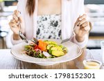 Young woman eating healthy salad at restuarant, Healthy lifestyle, diet concept