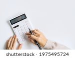 Accountant using calculator on desk office on white background with copy space, Top view