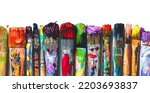 Small photo of Row of artist paintbrushes closeup on white. Artistic brushes smeared with paints on white background.