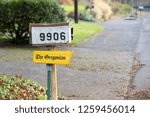Small photo of Portland, OR / USA - December 12 2018: Mailbox with yellow dedicated holder for "The Oregonian" newspaper.