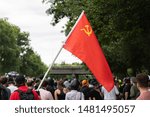 Small photo of Portland, OR / USA - August 17 2019: Antifa protest - Red soviet era communist flag with star, hammer and sickle on it carried by the demonstrator.