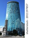 Small photo of Birmingham, England - August 11, 2014: A religious shrine and modern glass skyscraper typify the architectural diversity found in the city of Birmingham, England.