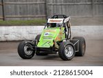 Small photo of Middletown, NY, USA - October 23, 2021: Short track racer Steve Kyzer slides his Sprint Car through a turn at Orange County Fair Speedway in Middletown, NY.