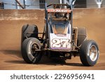 Small photo of Indianapolis, IN, USA - May 23, 2019: Race driver Jason McDougal slides his USAC Silver Crown race car through a turn on the Indiana State Fairgrounds mile. Car is slightly blurred to show speed.