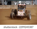 Small photo of Indianapolis, IN, USA - May 23, 2019: Race driver Jason McDougal slides his USAC Silver Crown race car through a turn on the Indiana State Fairgrounds mile. Car is slightly blurred to show speed.