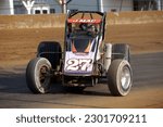 Small photo of Indianapolis, IN, USA - May 23, 2019: Race driver Jason McDougal slides his USAC Silver Crown race car through a turn on the Indiana State Fairgrounds mile. Car is slightly blurred to show speed.