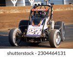 Small photo of Indianapolis, IN, USA - May 23, 2019: Race driver Jason McDougal slides his USAC Silver Crown race car through a turn on the Indiana State Fairgrounds mile. Car is slightly blurred to show speed.