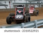 Small photo of Indianapolis, IN, USA - May 27, 2011: Chris Urish leads Kyle Larson through a turn on the Indiana State Fairgrounds mile. Cars slightly blurred to show speed and action.
