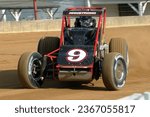 Small photo of Indianapolis, IN, USA - May 22, 2014: Racer Caleb Armstrong slides his USAC Silver Crown car through a turn on the Indiana State Fairgrounds mile. Car slightly blurred to show speed and action.