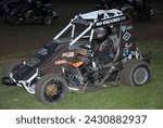 Small photo of Kutztown, PA, USA - July 19, 2023: Aidan Goldsmith parks his disabled 600cc Micro Sprint race car in the infield during a race at a small dirt track in Pennsylvania.