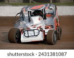 Small photo of Middletown, NY, USA - May 7, 2023: Racer Dillon Steuer steers his powerful Dirt Modified stock car around New York's Orange County Fair Speedway. Car slightly blurred to show speed and action.