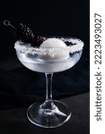 Small photo of Full Moon Martini with Blackberry Garnish: Vodka cocktail with an opaque white ice sphere and fruit garnish