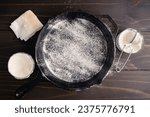 Small photo of Greased and Floured Cast-Iron Skillet: Frying pan coated with vegetable oil and dusted with all-purpose flour to prevent sticking