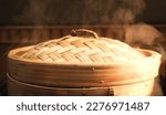 Small photo of Steaming Dim Sum Bamboo Steamer with Bun Inside. Chinese culture.