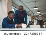 Small photo of Two African American business partners are working on a laptop together on a joint project. Mutual assistance and establishment of social contacts