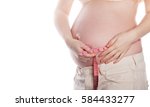 Small photo of Lovely pregnant woman measuring belly. Uneventful pregnancy. Man is unrecognizable.