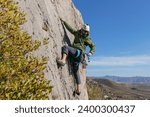 Male climber picking gear on waist