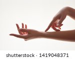 Gentle motion and gesture female hands. Be gentle to yourself metaphor. Close up of young woman softly touching her hands on white background. Elegant and graceful hands with slender graceful fingers.