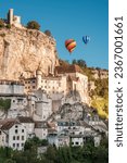 Small photo of Rocamadour, France - 24th September 2023: Hot air balloons pass the medieval town of Rocamadour in the Lot region of France during the Montgolfiades de Rocamadour balloon festival