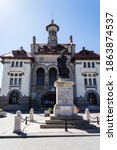 Small photo of CONSTANTA, ROMANIA - SEPTEMBER 13, 2020: Museum of National History and Archeology and the Ovidiu latin poet statue.
