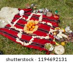 Small photo of Ceremony in homage to Pachamama -indigenous ritual of the peoples Ecuador (Azuay) around a Chakana or Andean cross, made with seeds, corn, fruits and elements that allude to fire, earth, air, water.