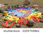 Small photo of Andean cross, Chakana or Ceremony in homage to Pachamama (Mother Earth) - is an aboriginal ritual of the indigenous peoples of the central Andes. Cross made from plants, food, seeds. Ecuador, Cuenca