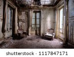 Chairs In An Abandoned Room In...