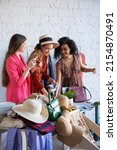 Small photo of Young women at swap party. Casual clothes, shoes, hats, bags, jewellery. Idea of exchange your old wardrobe for new. Eco friendly cloth concept. Zero waste shopping, reduce and reuse, donation