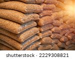 Small photo of 1 ton of wooden pellets packed in 15kg bags. Wooden pellets stacked in plastic bags. Heating fuel is delivered to the household to heat interiors in winter. Sustainable future concept.