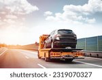 Reliable Towing and Recovery Services: 24-7 Assistance for Vehicle Breakdowns and Accidents. Emergency roadside assistance on the highway. side view of the flatbed tow truck with a damaged vehicle