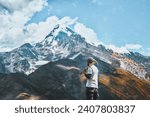 Small photo of Hiker with pickaxe view from the back. Amidst the Silence of the Alps. Journey Unfolds Capturing Moments of Solitude and Adventure. In the Heart of Nature a Lone Explorer Stands Against the Alps