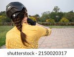 Small photo of Rear view of female cyclist having neck pain from riding a bike long time. Poor posture is a major contributor to neck pain whilst cycling.