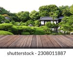 Wooden table top with blurred garden and japan house.