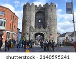 Small photo of 17th March 2022, Drogheda, County Louth, Ireland. People near Saint Laurence's Gate, a barbican built in the 13th century as part of the walled fortifications of the medieval town.