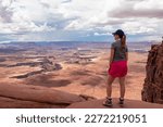 Small photo of Woman with scenic view of Split Mountain Canyon seen from Green River Overlook, Moab, Canyonlands National Park, San Juan County, Utah, USA. Looking at features of The Maze district and White Rim Road
