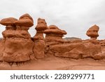 Small photo of Close up view on unique eroded Hoodoo Rock Formations at Goblin Valley State Park in Utah, USA, America. Sandstone rocks called goblins which are mushroom-shaped rock pinnacles. Overcast day in summer