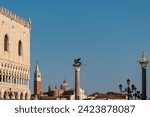 Small photo of Venice, Italy: 6 12 2022: Scenic view of statue of Lion of Venice, Statue of Saint Teodoro of Amaseat and Church of San Giorgio Maggiore in Venice, Veneto, Northern Italy, Europe. Venetian architectur