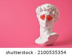 fake bust of david with red glass hearts on the eyes, love concept, valentine's day congratulations