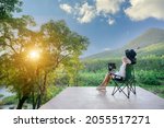 Asian female tourists wake up early to see the rising sun. Travel she likes to travel in style. beautiful nature forests and mountains work happy holidays with freelance work on laptop