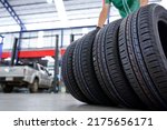 A tire changer is in the process of bringing new tires in stock and replacing them at a service center or auto repair shop for the automotive industry.