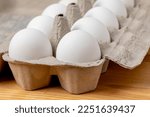 Fresh white chicken eggs in carton. Organic, cage-free and poultry farming concept. 